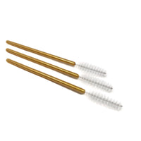 Three gold-colored brushes with bristle heads on a white background